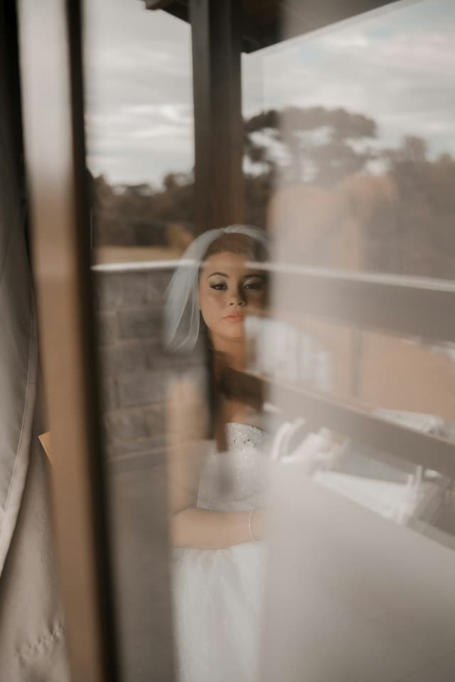 A bride in softly reflected window light
